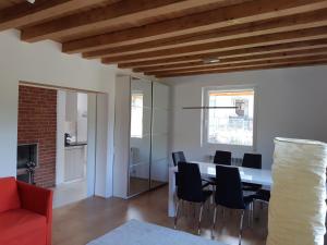 a living room with a dining room table and chairs at House of Laura in Băile Tuşnad