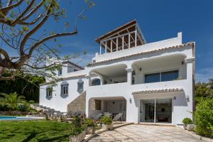 a white villa with a swimming pool at Luxury Villa Marbella with nice garden, Pool and Jacuzzi BY Varenso Holidays in Marbella