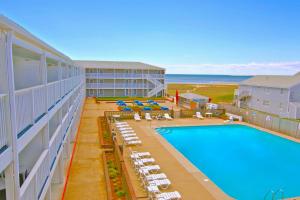 a view of a hotel with a swimming pool and chairs at Sandcastle Resort in Provincetown