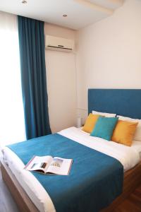 a bedroom with a bed with two books on it at Rio in Tbilisi City