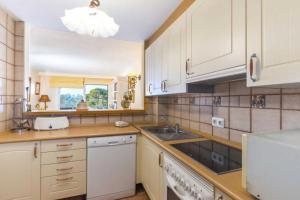 a kitchen with white cabinets and a sink at The Torrent's Observer Holiday Home ( Cala Pi ). Smart Tv. Netflix. Free Wifi in Cala Pi