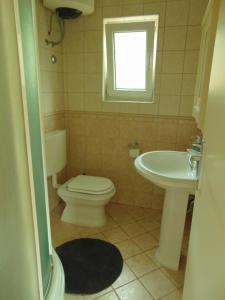 a bathroom with a toilet and a sink at COSTABELLA VISTA in Rijeka