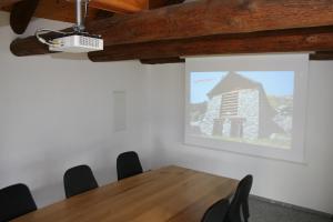 una sala riunioni con tavolo e schermo di proiezione di Agri Scinghiöra a Brontallo
