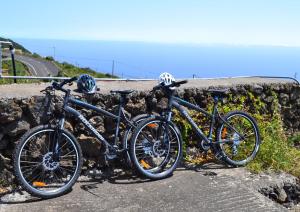 two bikes are parked next to a stone wall at Casa Rural Claudio in Mazo