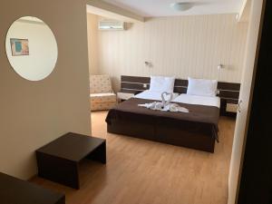 a hotel room with a bed and a mirror at Family Hotel Piter in Golden Sands