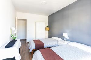 2 camas en una habitación pequeña con paredes azules en PARADISE IBIZA ( Apto. Turístico 1 llave ) en San Antonio