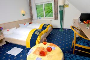 a hotel room with a bed and a table at Seehotel OFF in Meersburg