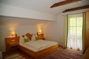 a bedroom with a bed and a window at Bio-Bauernhof Nichlgut in Eben im Pongau