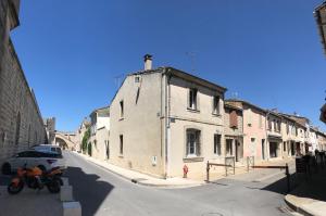 a street with buildings and a car parked on the street at Ô 36 Rempart Sud B&B in Aigues-Mortes +64 photos