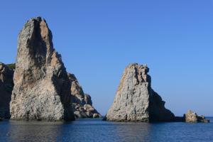 two large rocks in the water at Roses Studios in Karpathos