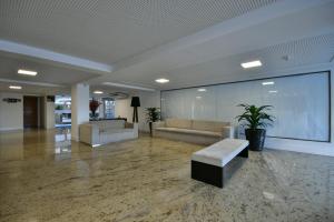 a lobby with couches and a couch and a table at Littoral Gold Flat in João Pessoa