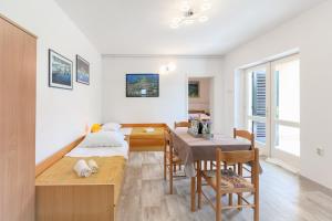 a room with a table and a dining room at Apartment Ema in Premantura +21 photos