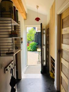 a hallway with a door leading to a patio at Guesthouse Boom in Watergang