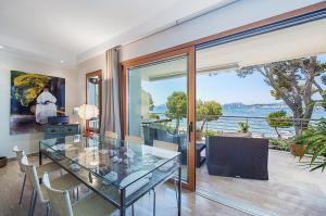 a glass dining room with a view of the water at Apartment Vora Dor in Port de Pollensa