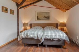 Un pat sau paturi într-o cameră la Landelijk Genieten