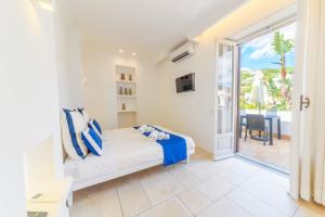 a bedroom with a bed and a balcony at Villa Fortuna Holiday Resort in Ischia