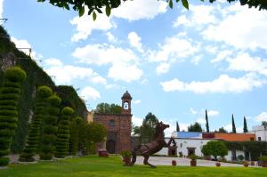 a statue of a horse in front of a building at Posada de la Aldea in San Miguel de Allende