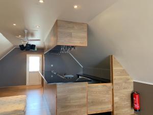 a kitchen with a black counter and wooden cabinets at North Star Apartments Rif in Snæfellsbær