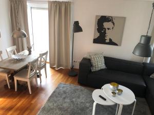 a living room with a black couch and a table at Ferienhaus am Emmerbach in Ascheberg