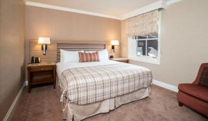 a hotel room with a bed and a chair at Sun Valley Resort in Sun Valley