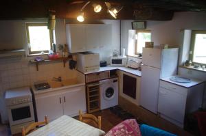 a kitchen with white cabinets and a washer and dryer at Gitavesnois - 4910 - in Willies