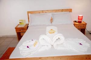 
A bed or beds in a room at Imans Hotel Daloa
