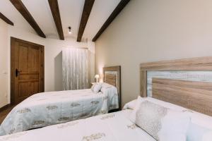 A bed or beds in a room at Casa Rural Monte Perdido