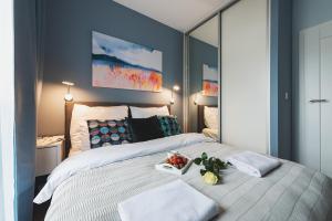 a bedroom with a large bed with a mirror at Airport Okecie Wagonowa Serviced Apartments in Warsaw