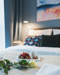 a plate of fruit on a table in a hotel room at Airport Okecie Wagonowa Serviced Apartments in Warsaw