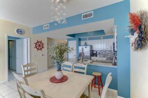 a dining room and kitchen with a table and chairs at Majestic Sun 913A Miramar Beach (Condo) in Destin