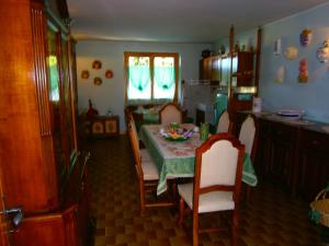 a kitchen with a table with chairs and a table and a tableablish at B&B Carmen Biondani in Pescantina