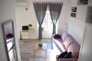 a living room with a couch and a table at Apartman ''Nicole'' in Pula