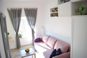 a living room with a couch and a table at Apartman ''Nicole'' in Pula