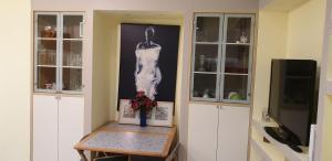 a room with a painting of a woman on the wall at Grattacielo Apartment in Rapallo