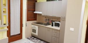 a small kitchen with a sink and a microwave at Grattacielo Apartment in Rapallo +8 photos