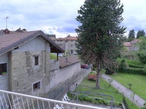 a view of a building with a tree in a yard at l'Oca Mannara in Ameno