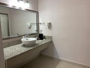 a bathroom with a sink and a large mirror at Death Valley Inn & RV Park in Beatty