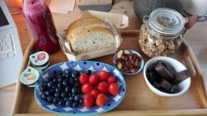 a table topped with a plate of fruit and bread at Da La Babi B&B in Arco
