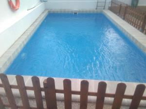 a large blue pool with a wooden fence at VILLA GARDEN in Tarragona