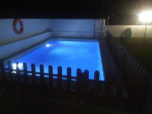 a swimming pool at night with a light in it at VILLA GARDEN in Tarragona