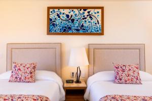 Postel nebo postele na pokoji v ubytování Villa del Palmar Beach Resort & Spa + 37 fotografií