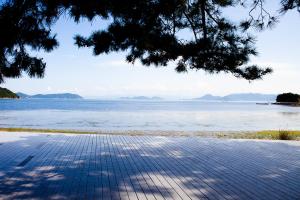 a view of a body of water with a tree at Machicado in Tamano