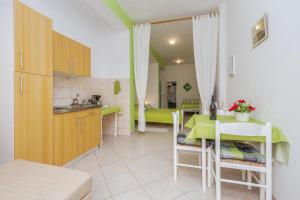 kuchnia i jadalnia ze stołem w pokoju w obiekcie Studio Apartments Romina w mieście Vrsar