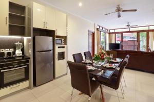 a kitchen and dining room with a table and chairs at Villa Nova in Legian