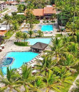 an aerial view of a resort pool with palm trees at Hotel Village Porto de Galinhas - Apartamento 215 in Porto De Galinhas