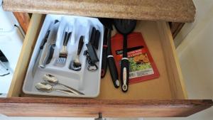 a drawer filled with utensils in a cabinet at Golden Sand Oceanfront in Hollywood