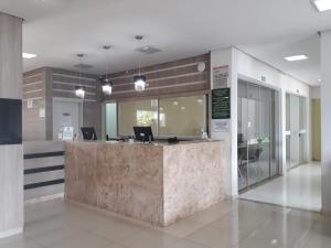 a lobby with a reception desk in a building at Apartamento LAGOA QUENTE FLAT SERVICE in Caldas Novas