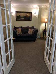 a living room with a couch in a room at Niagara Mansion Carriage Suite in Lewiston