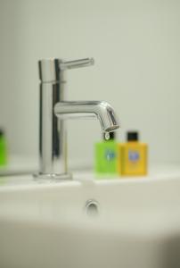 a sink with a faucet on top of it at Nadias Hotel Cenang Langkawi in Pantai Cenang