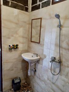a bathroom with a sink and a shower at Gubug Balian Beach Bungalow in Selemadeg